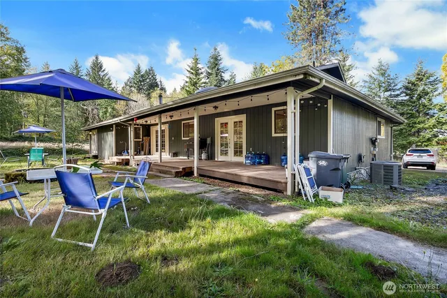 a view of a house with a yard patio and fire pit