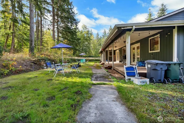 a view of a house with backyard porch and sitting area