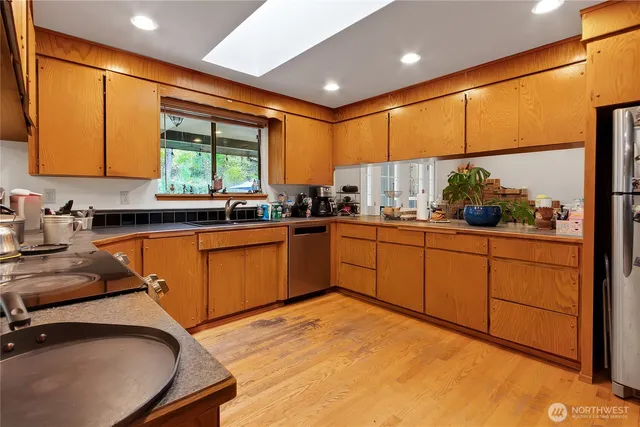 a kitchen with stainless steel appliances granite countertop sink stove and cabinets