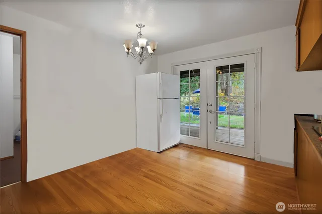 a view of a room with a window and wooden floor
