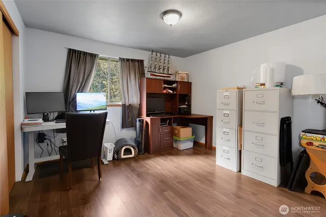 a view of a workspace with furniture and a window