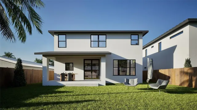 a view of a white house with a big yard and potted plants