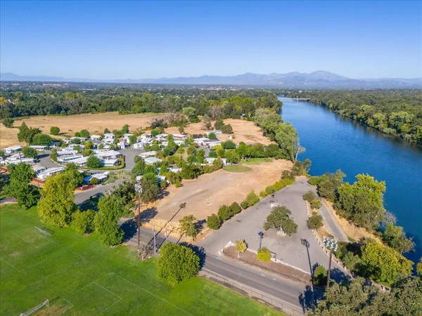 an aerial view of a house with a yard and lake view