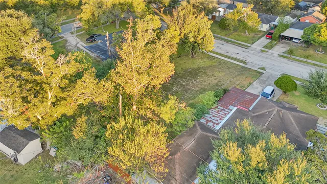 a aerial view of a house with a yard basket ball court