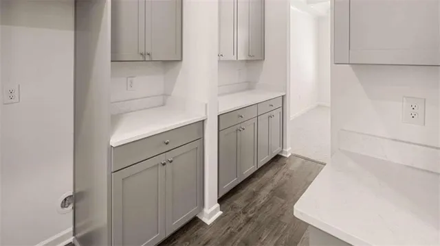 a view of an empty room with fireplace and a window