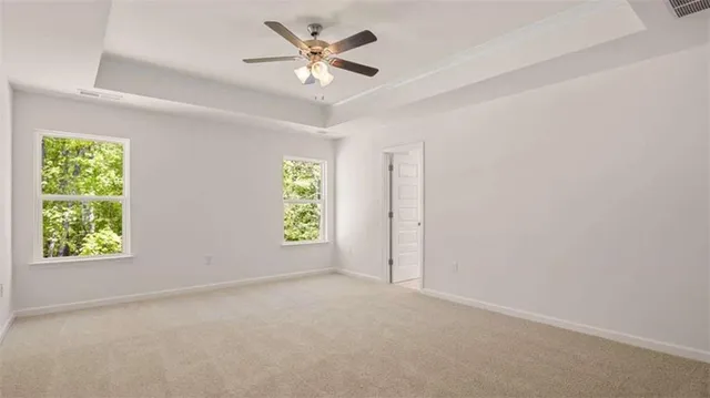 a view of a house with a backyard and road