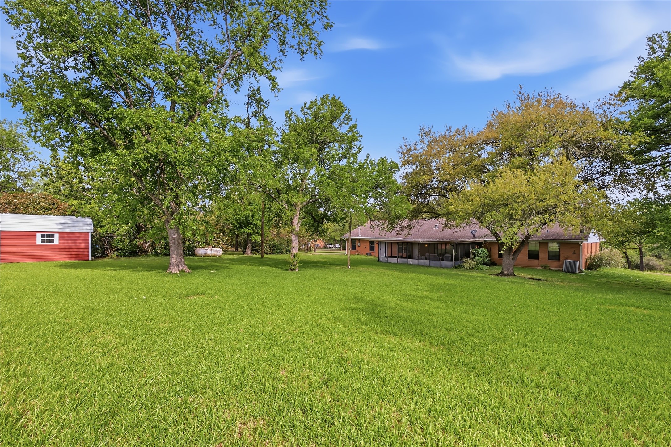 807 Standley Road Madisonville, TX 77864 - Photo 34 of 35 a front view of a house with a yard and trees