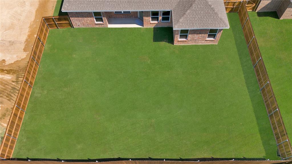 111 Panther Loop Mabank, TX 75147 - Photo 6 of 27 Fully sodded, fenced and sprinklered backyard and a covered patio for optimum enjoy for kids, pets and entertaining!