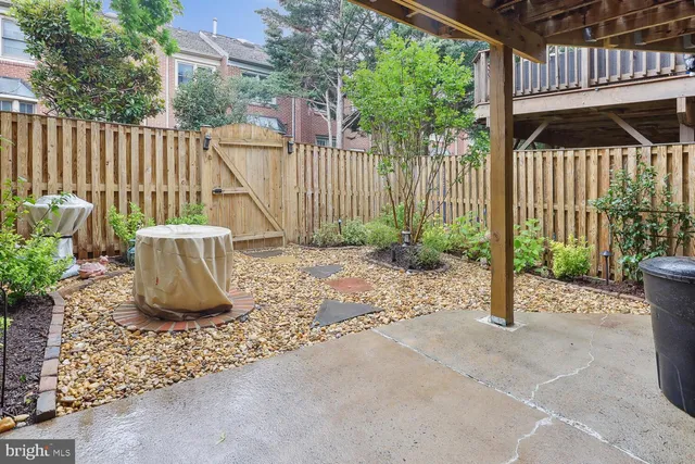 a view of a deck with a table and chair and wooden fence