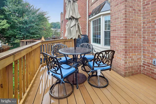 a view of balcony with wooden floor and seating space
