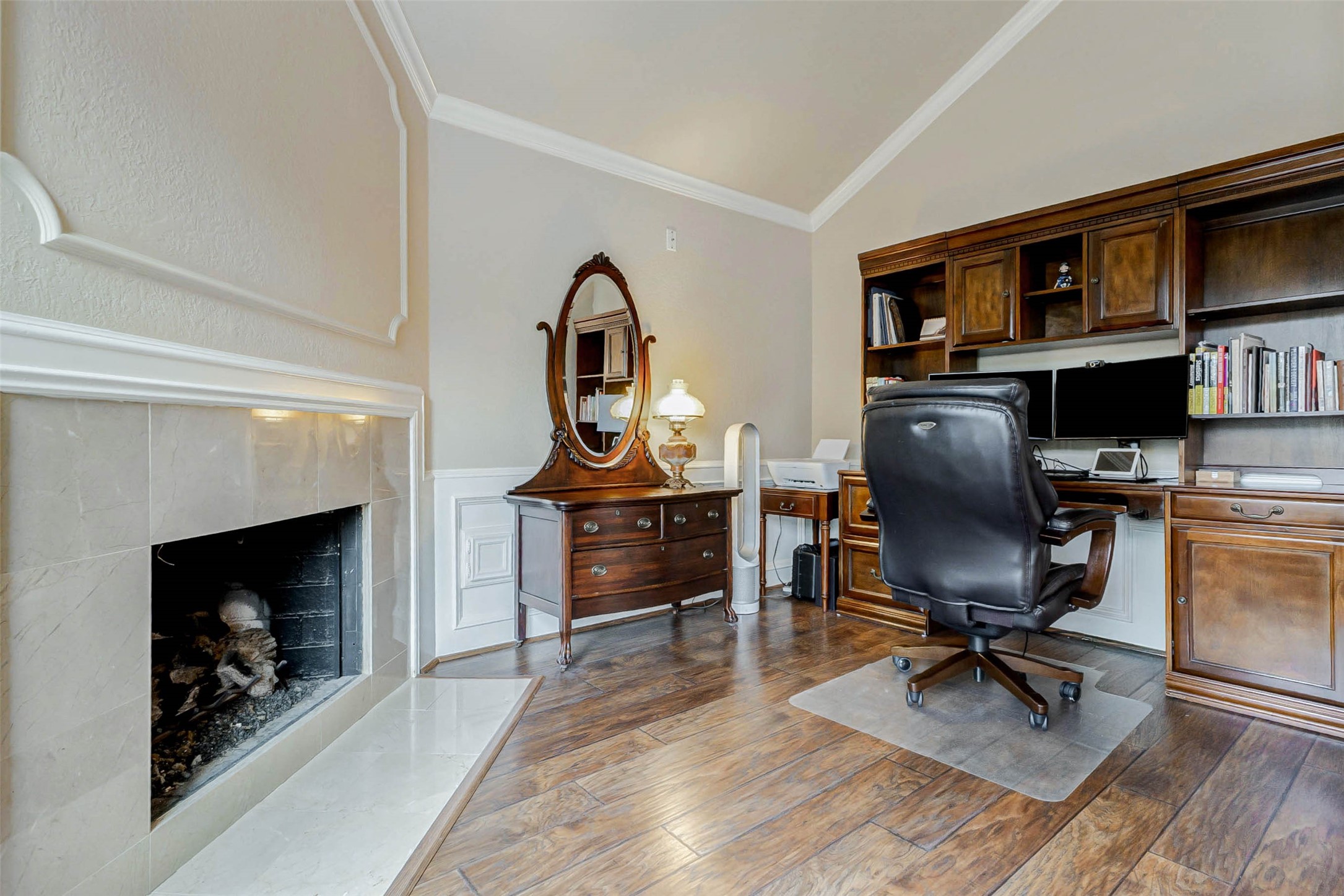 15811 Spring Forest Drive Houston, TX 77059 - Photo 18 of 27 This inviting primary suite features a cozy fireplace, perfect for relaxation and warmth, adding a touch of elegance and comfort to your personal retreat.