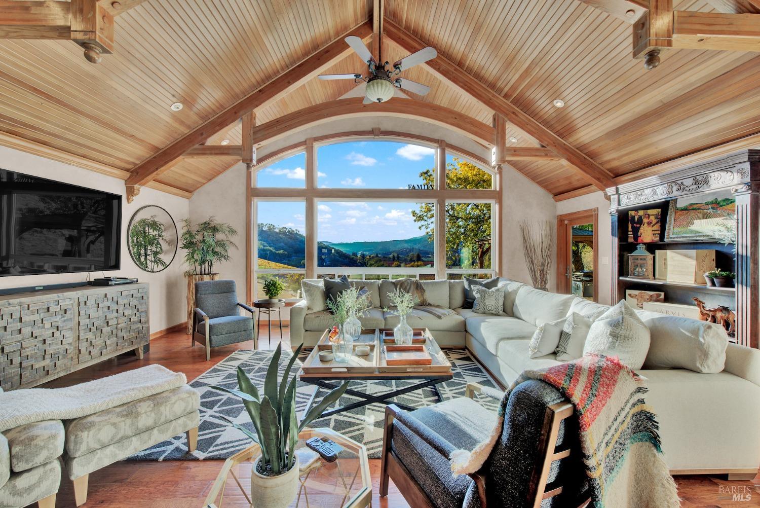 a living room with furniture fireplace and a large window