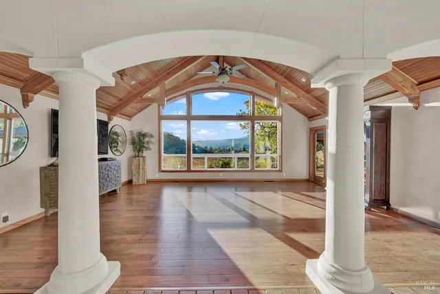 a dining room with furniture and wooden floor