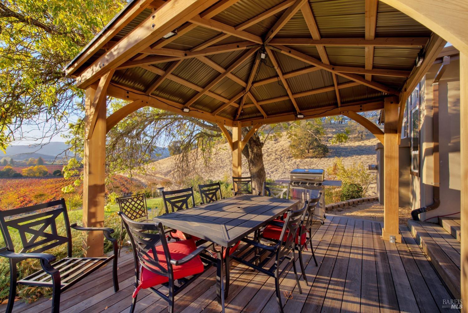 5066 Clayton Road Fairfield, CA 94534 - Photo 39 of 75 a patio with wooden floor a yard a table and chairs
