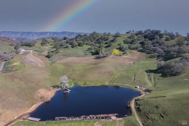 an aerial view of a house with a yard