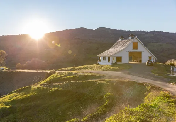 a living room with fireplace furniture and a large window