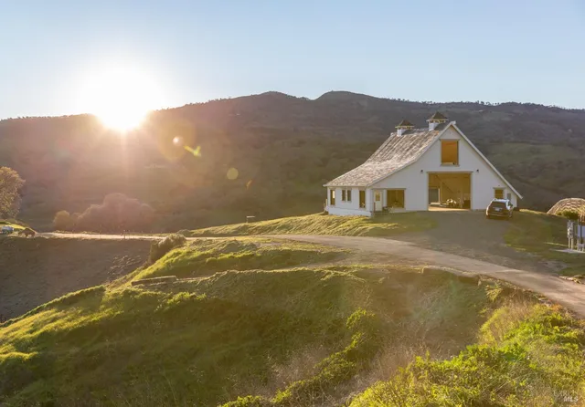 a living room with fireplace furniture and a large window