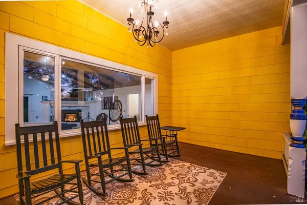 a living room with furniture a fireplace and a table