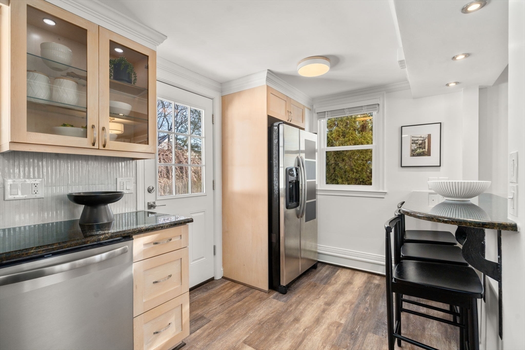 266 Hunnewell Street, Unit 266 Needham, MA 02494 - Photo 11 of 39 a kitchen with stainless steel appliances granite countertop a refrigerator and a stove top oven