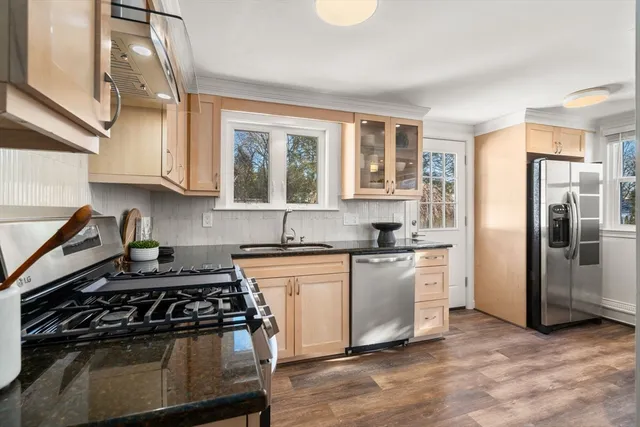a kitchen with stainless steel appliances granite countertop a stove and a refrigerator