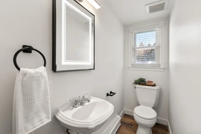 a bathroom with a sink toilet and a mirror