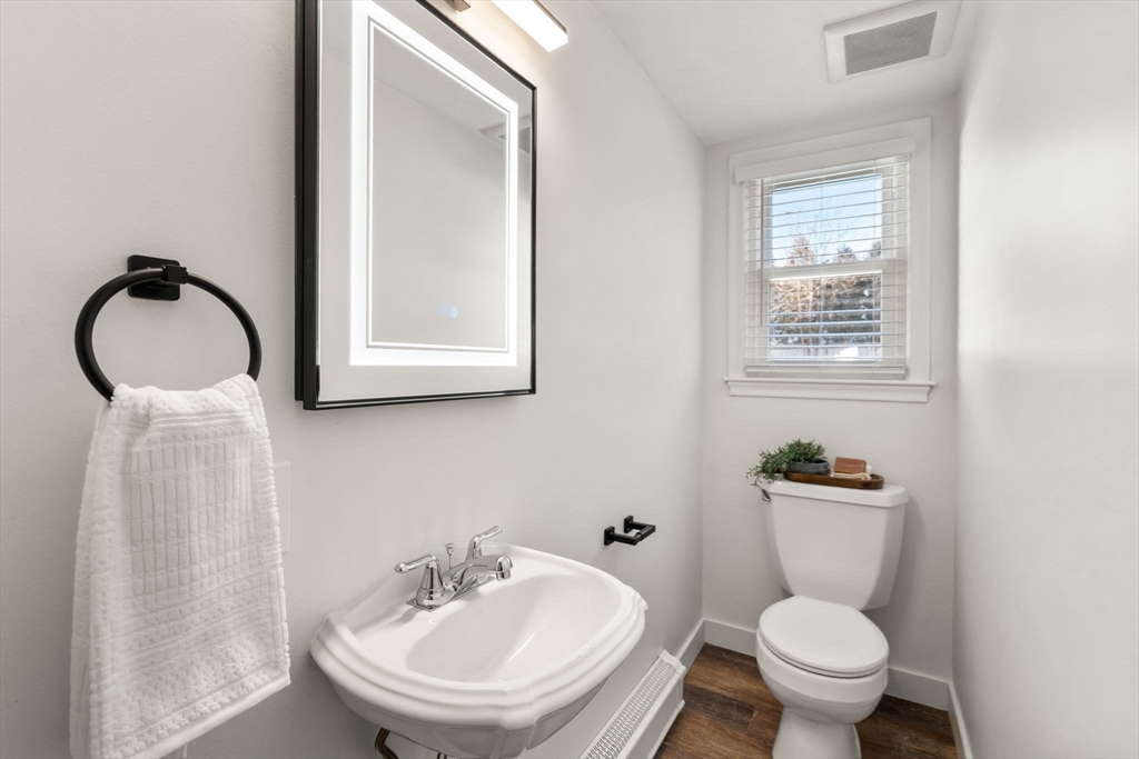 266 Hunnewell Street, Unit 266 Needham, MA 02494 - Photo 14 of 39 a bathroom with a sink toilet and a mirror
