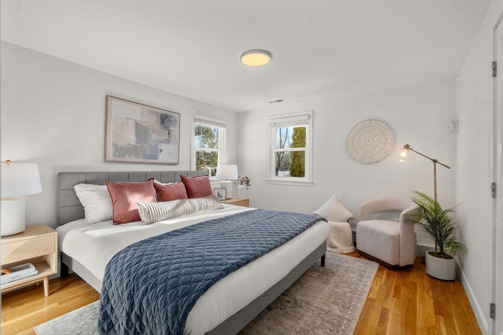 266 Hunnewell Street, Unit 266 Needham, MA 02494 - Photo 18 of 39 a bedroom with a bed and a chandelier