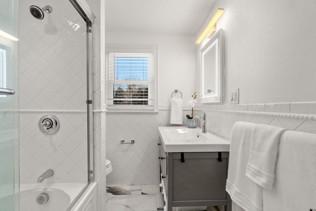 266 Hunnewell Street, Unit 266 Needham, MA 02494 - Photo 20 of 39 a bathroom with a sink a toilet and shower