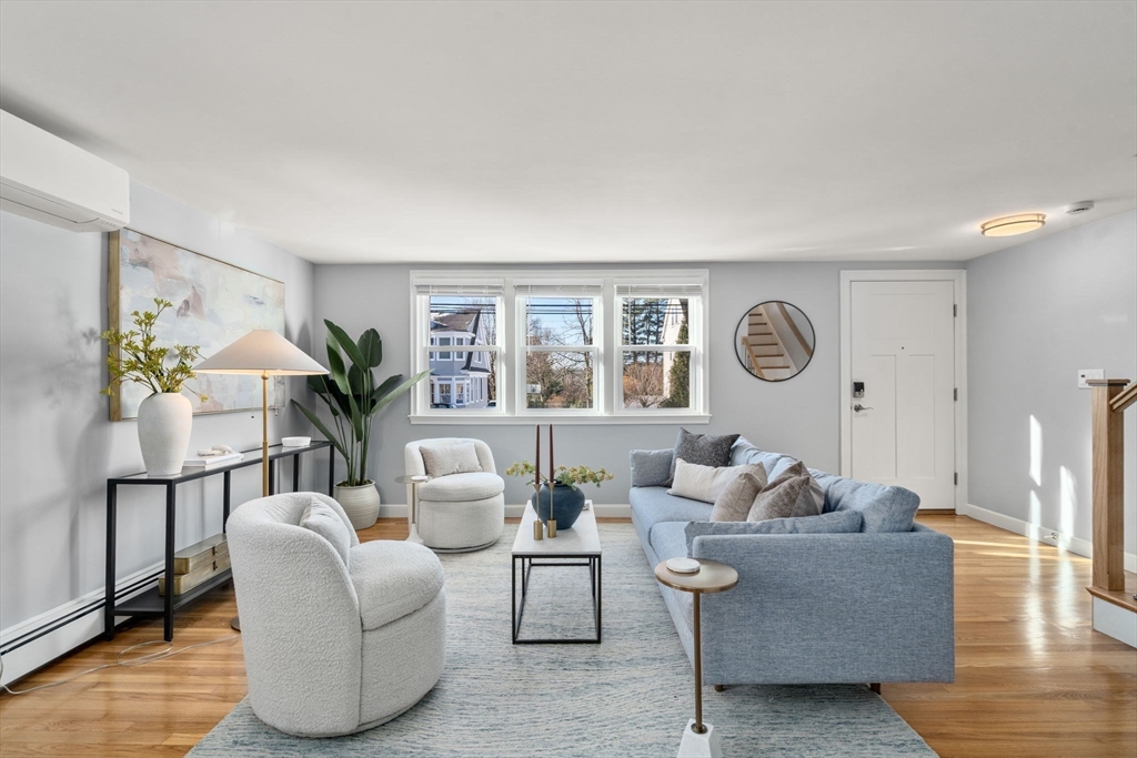 266 Hunnewell Street, Unit 266 Needham, MA 02494 - Photo 2 of 39 a living room with furniture and a large window
