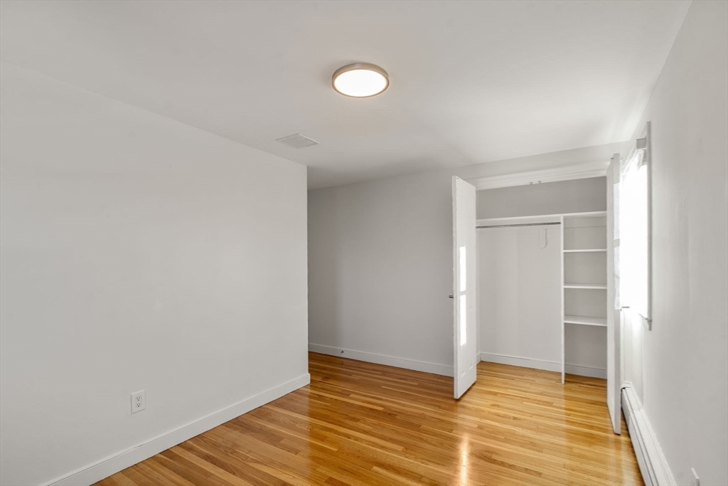 266 Hunnewell Street, Unit 266 Needham, MA 02494 - Photo 22 of 39 a view of an empty room with wooden floor