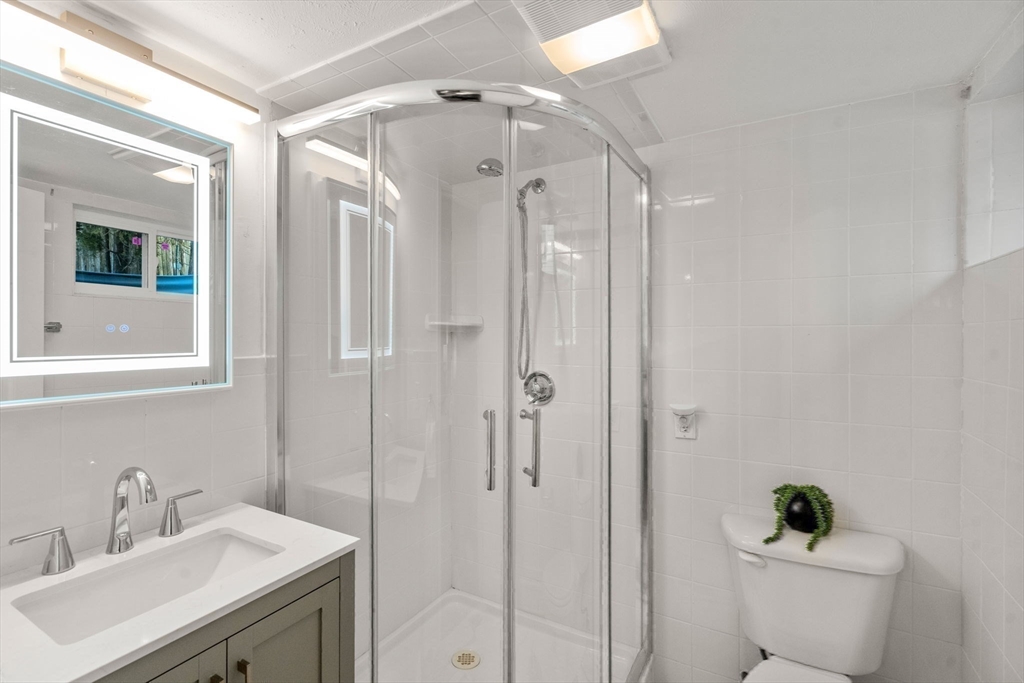 266 Hunnewell Street, Unit 266 Needham, MA 02494 - Photo 31 of 39 a bathroom with a sink a toilet and shower