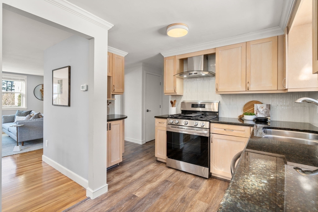 266 Hunnewell Street, Unit 266 Needham, MA 02494 - Photo 9 of 39 a kitchen with stainless steel appliances granite countertop a stove and a refrigerator