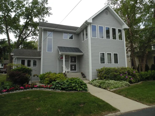 a front view of a house with a garden