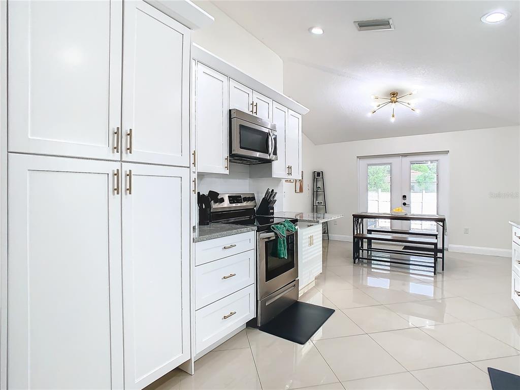 2907 West Arch Street Tampa, FL 33607 - Photo 12 of 48 a kitchen with white cabinets and appliances