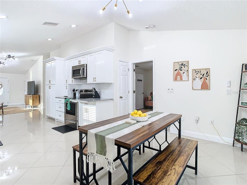 2907 West Arch Street Tampa, FL 33607 - Photo 15 of 48 a kitchen with stainless steel appliances a dining table and chairs