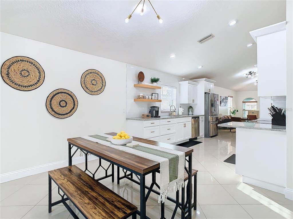 2907 West Arch Street Tampa, FL 33607 - Photo 16 of 48 a kitchen with a table chairs and a stove top oven