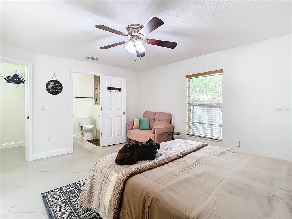 2907 West Arch Street Tampa, FL 33607 - Photo 20 of 48 a bedroom with a bed and a chandelier