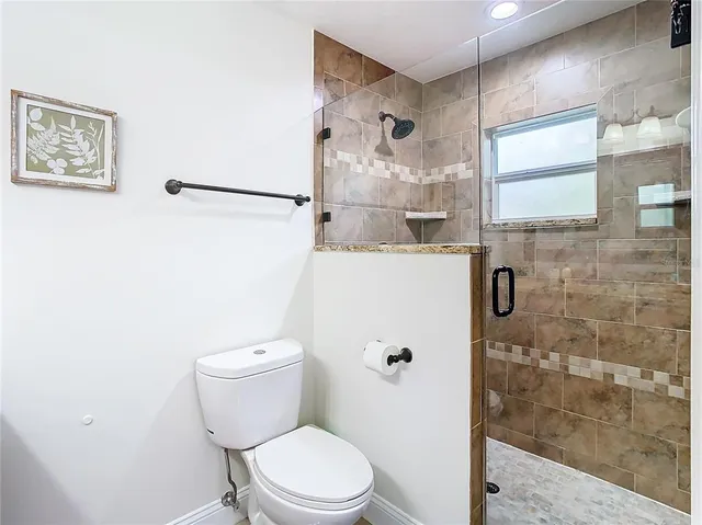 a bathroom with a toilet and a shower