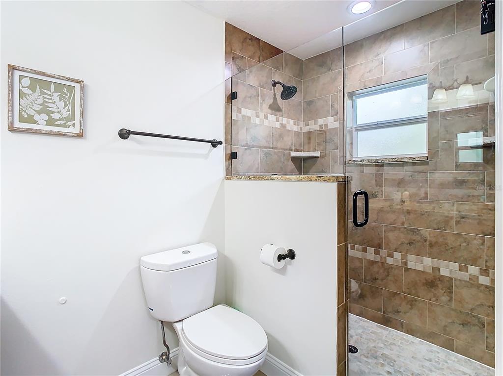 2907 West Arch Street Tampa, FL 33607 - Photo 24 of 48 a white toilet sitting next to a bathroom sink