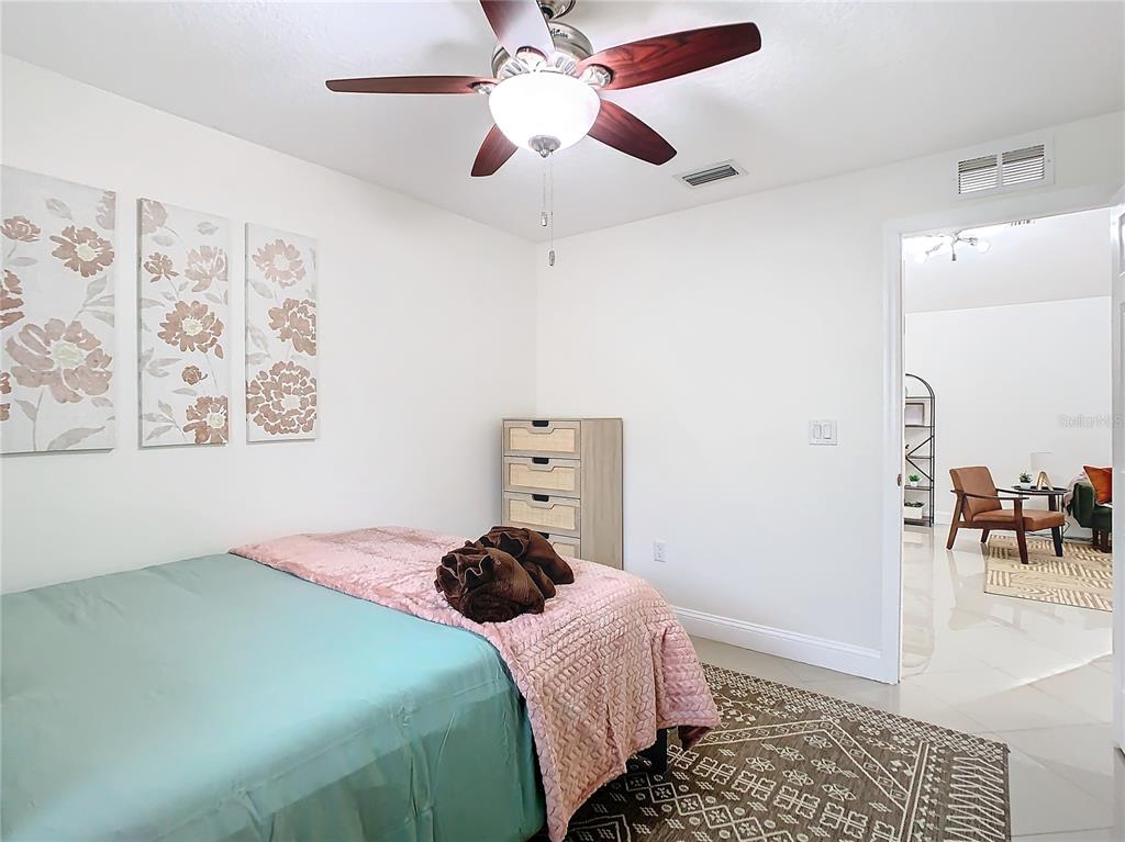 2907 West Arch Street Tampa, FL 33607 - Photo 26 of 48 a bedroom with a bed and a chandelier