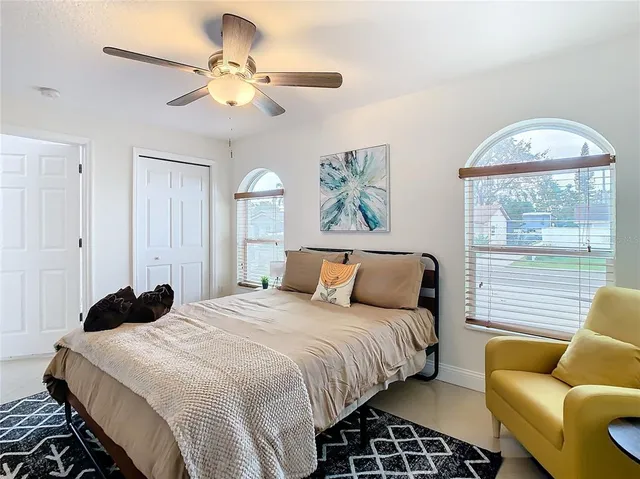 a bedroom with a large bed and a chandelier