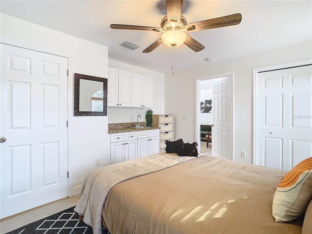 2907 West Arch Street Tampa, FL 33607 - Photo 31 of 48 a bedroom with a large bed and a chandelier