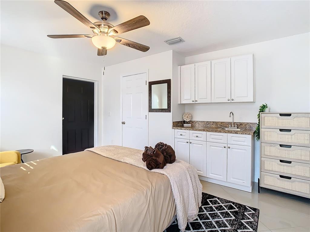 2907 West Arch Street Tampa, FL 33607 - Photo 32 of 48 a bedroom with a bed and a dresser