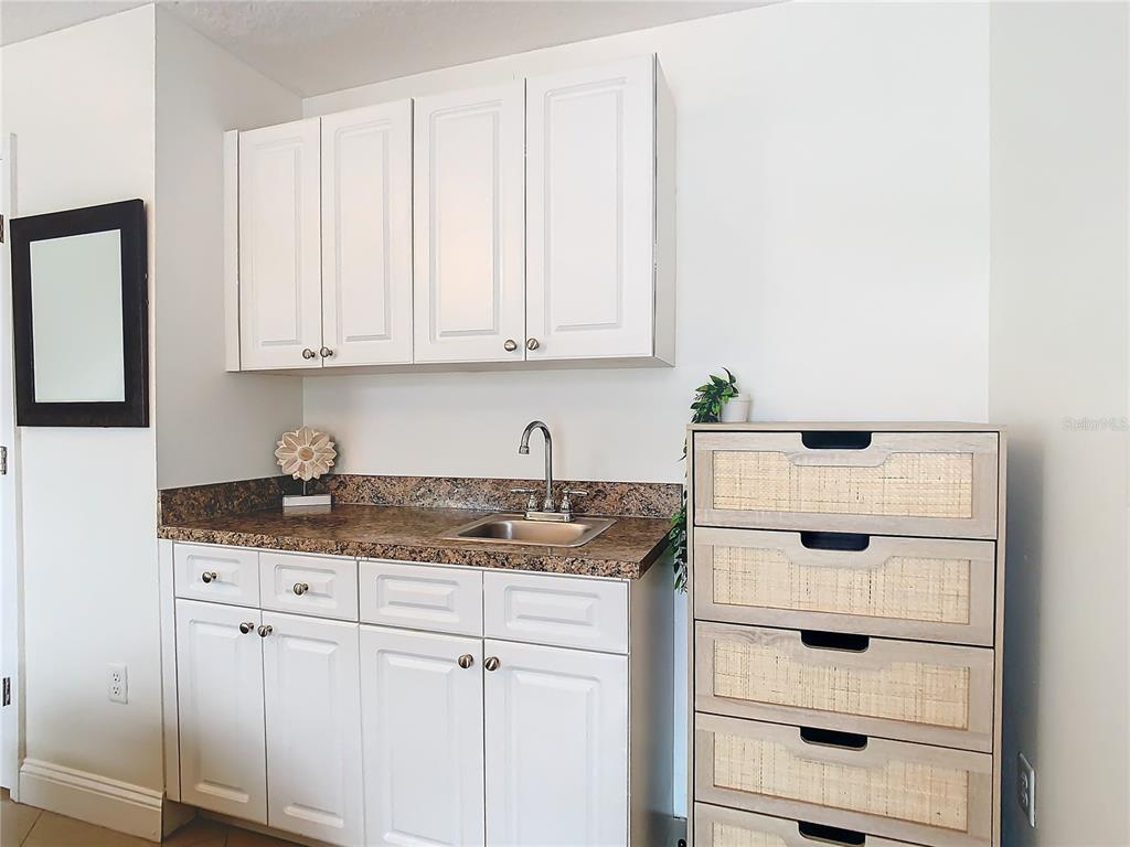 2907 West Arch Street Tampa, FL 33607 - Photo 33 of 48 a kitchen with granite countertop white cabinets and sink