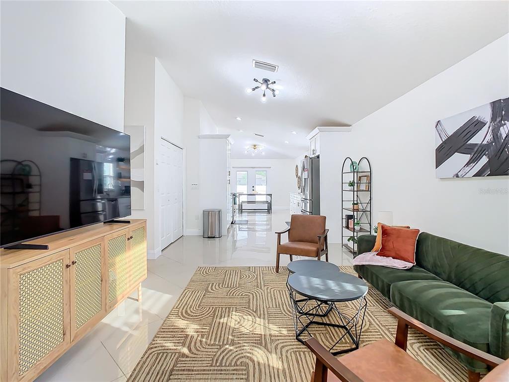 2907 West Arch Street Tampa, FL 33607 - Photo 4 of 48 a living room with furniture a rug and white walls