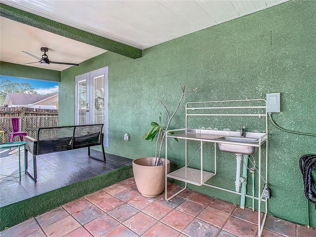 2907 West Arch Street Tampa, FL 33607 - Photo 44 of 48 a view of a patio with table and chairs potted plants