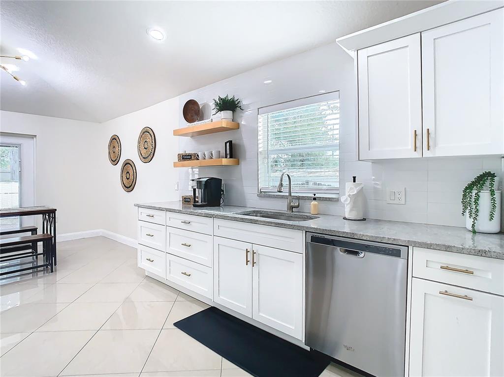 2907 West Arch Street Tampa, FL 33607 - Photo 9 of 48 a kitchen with stainless steel appliances granite countertop a sink and a cabinets