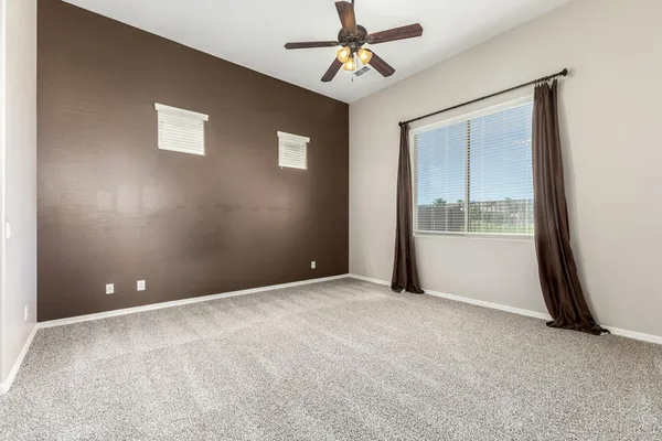 an empty room with windows and closet