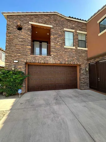 front view of a brick house with a yard