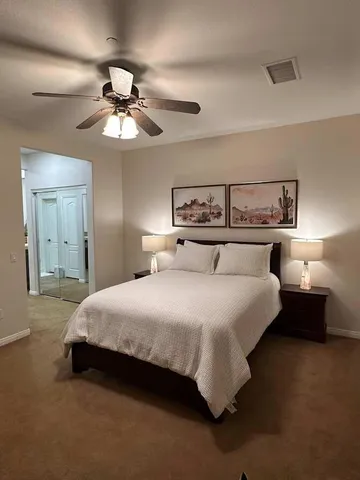 a bedroom with a bed and a chandelier